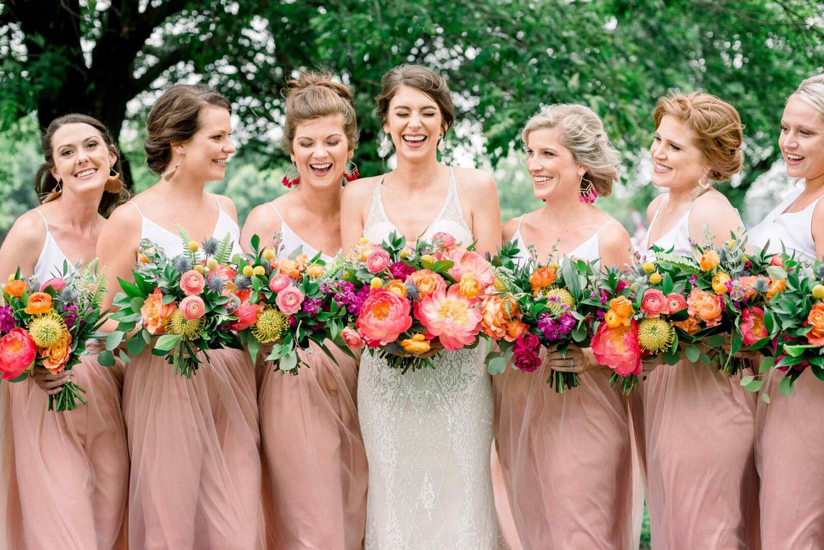 the bride and her bridesmaids holding bouquets of flowers
